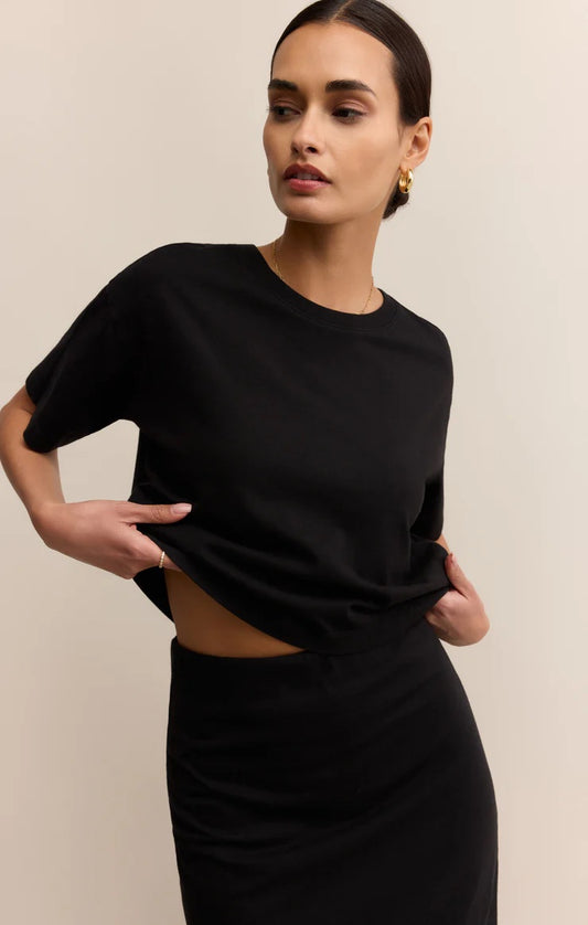 Woman wearing a black cut-out dress against a beige background | Z Supply On The Go Tee | Black