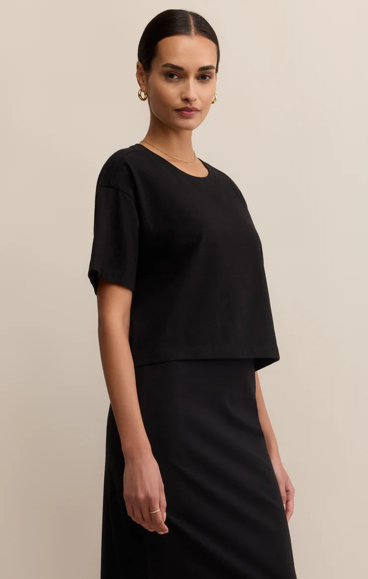 Woman wearing a black outfit against a beige background | Z Supply On The Go Tee | Black