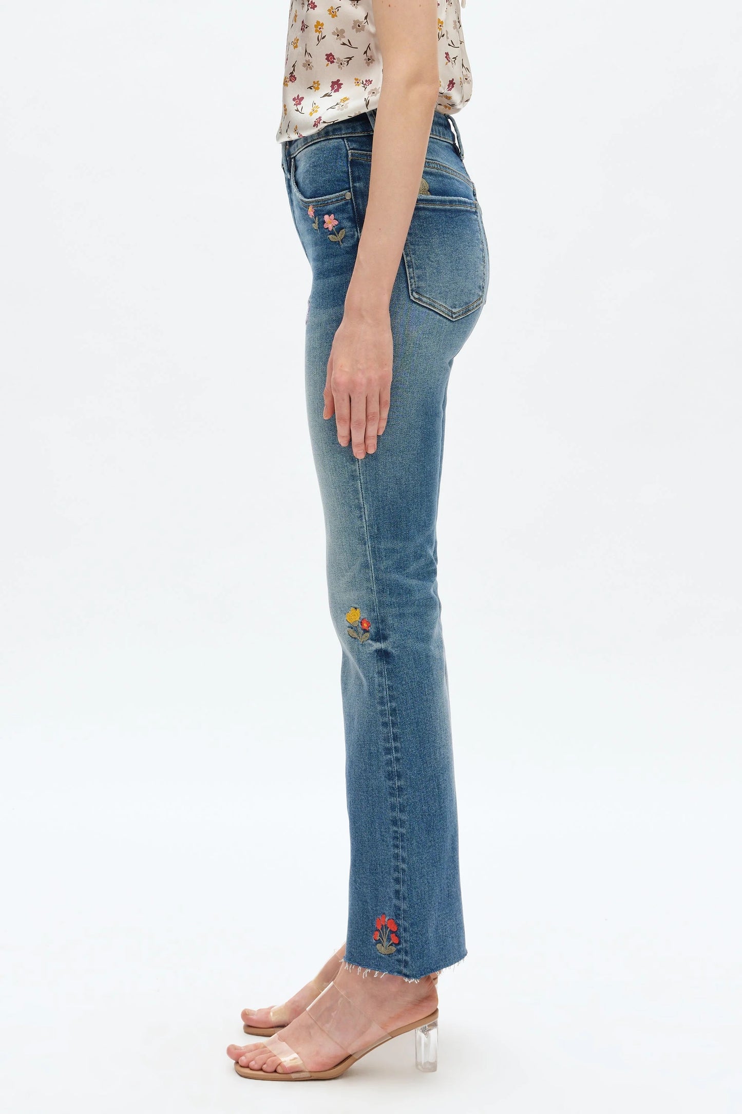 Blue jeans worn by a person on a white background