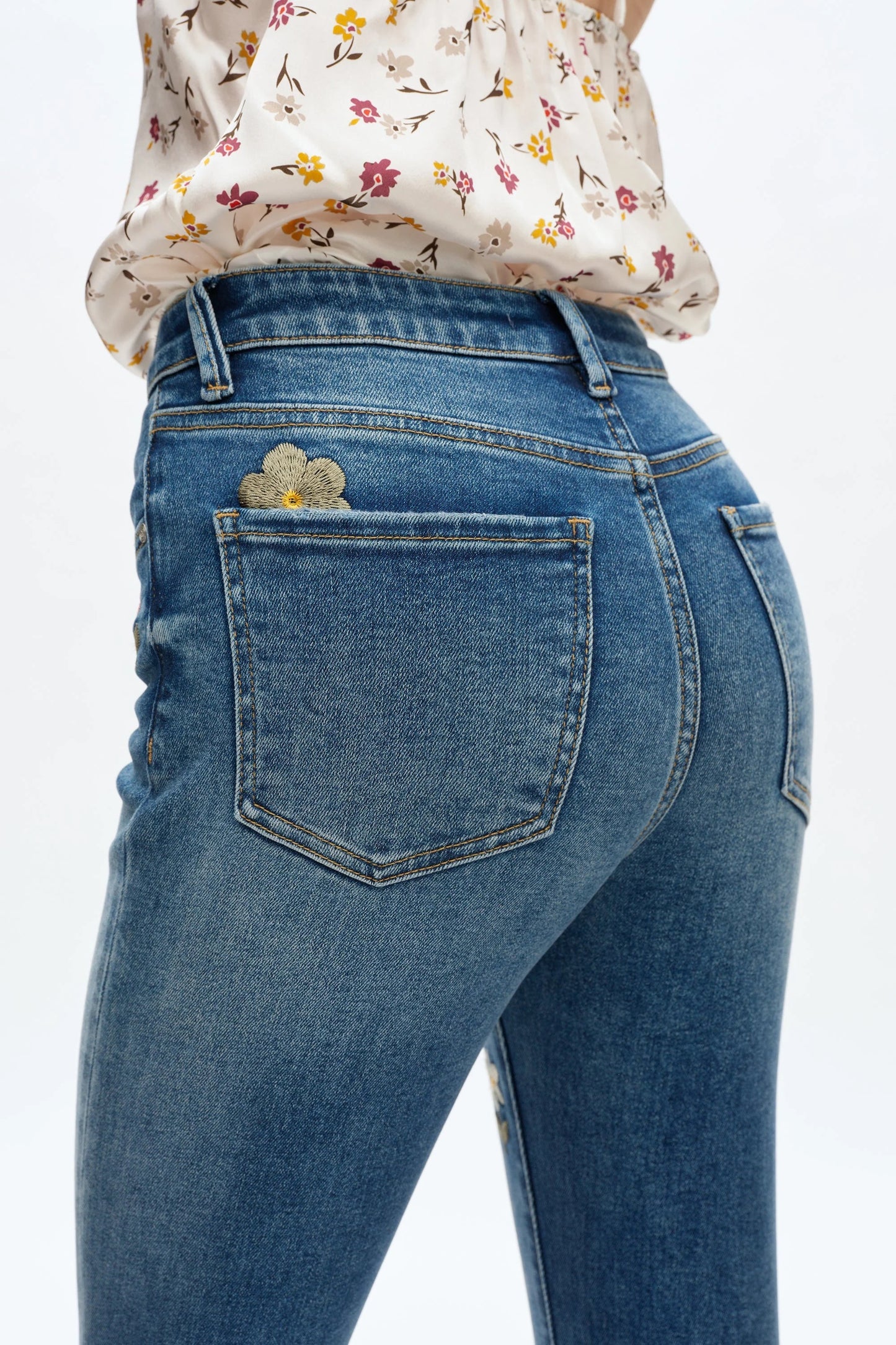 Blue jeans with floral design on a white background