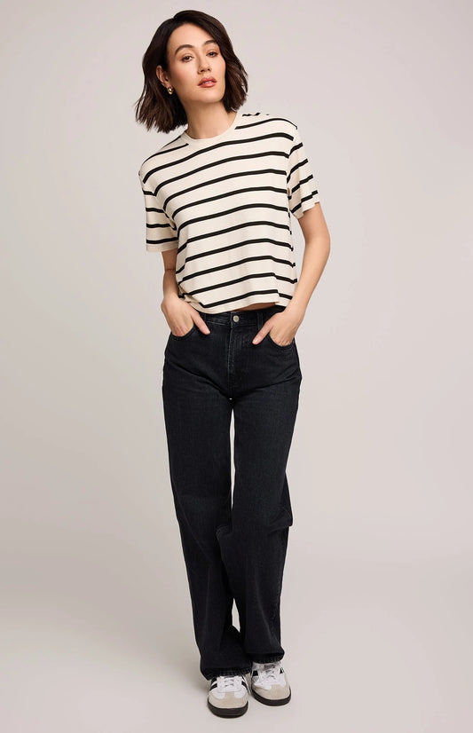 Woman wearing a striped shirt and black jeans against a plain background | Gentle Fawn Jaxon T-Shirt | Cream Stripe, Designed in Canada