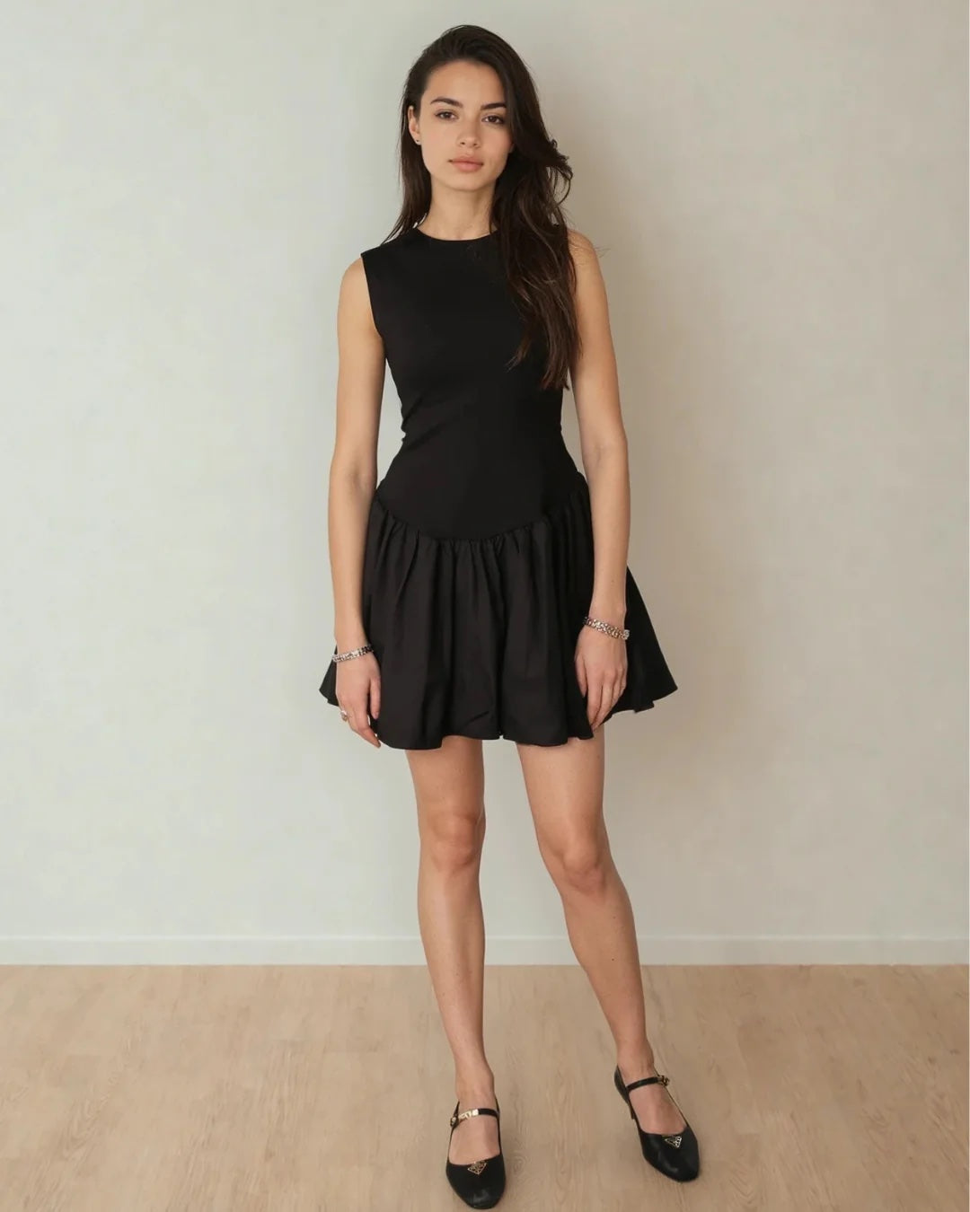 Woman wearing a black dress against a plain background